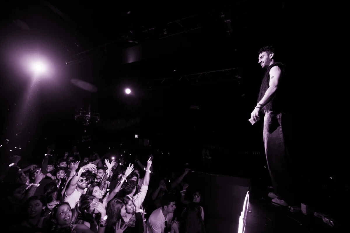 Amsal on stage in front of a cheering crowd